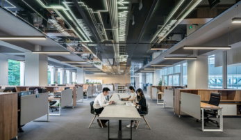 three people collaborating in open office