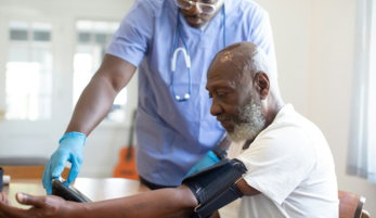 a doctor checking a patient's blood pressure