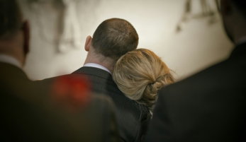 a man and a woman looking at the camera